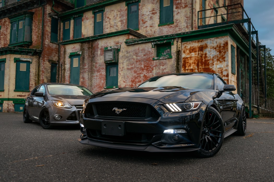 A-gray-ford-mustang-in-front-of-a-brick-wall-in-OKC