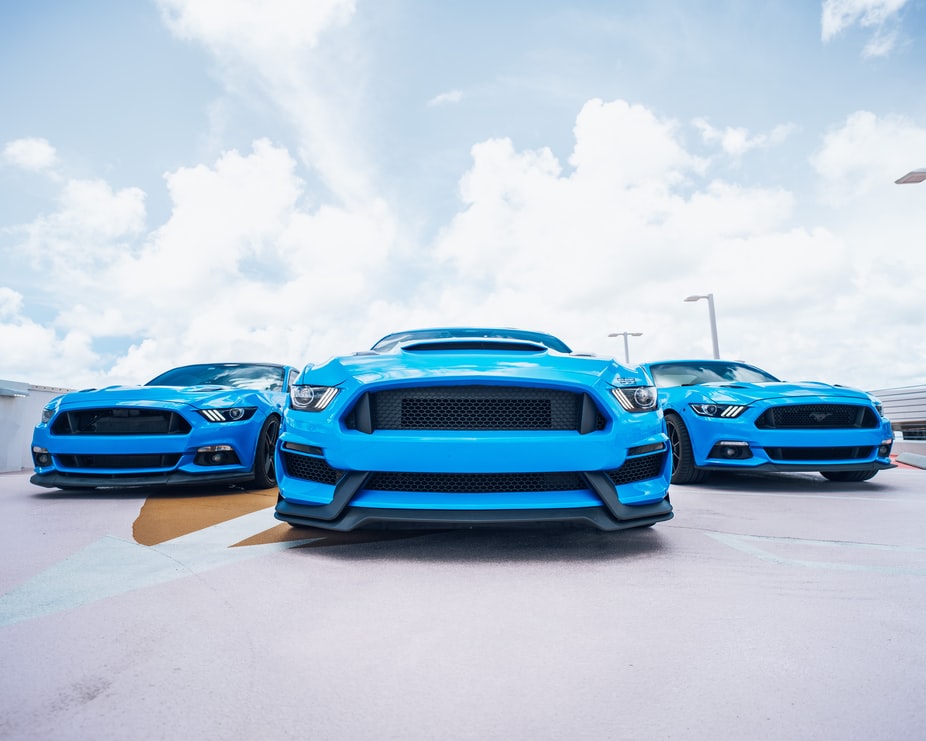 three-blue-ford-mustangs-in-a-parking-deck-in-Edmond